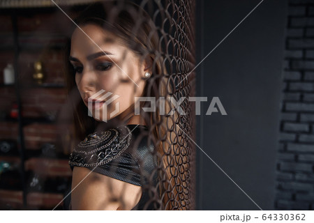 Beautiful seductive girl in sexaual leather dress. 64330362