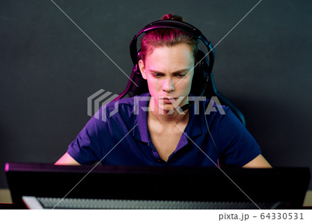 Young guy playing online game 64330531