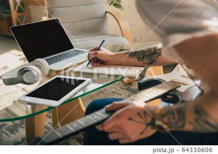 Young man studying at home during online courses or free information by hisself Young man studying at home during online courses or free information by hisself 64330606