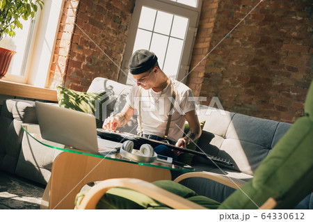 Young man studying at home during online courses or free information by hisself Young man studying at home during online courses or free information by hisself 64330612