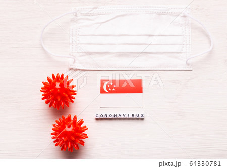 Coronavirus 2019-nCoV concept. Top view protective breathing mask and flag of Singapore. Novel Chinese Coronavirus outbreak. 64330781