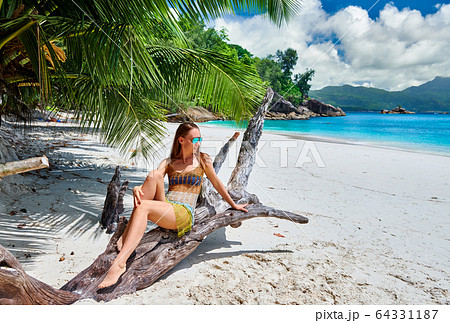 Woman on beach at Seychelles Woman on beach at Seychelles 64331187