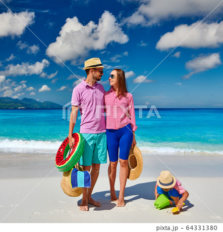 Family with three year old boy on beach. 64331380