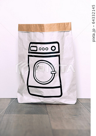 Paper craft package with a picture of the washing machine on the floor against the white background. Washbasin bag. Paper craft package with a picture of the washing machine on the floor against the white background. Washbasin bag. 64332145