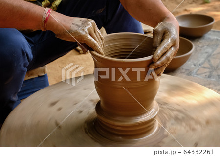 Indian potter hands at work, Shilpagram, Udaipur, Rajasthan, India Indian potter hands at work, Shilpagram, Udaipur, Rajasthan, India 64332261