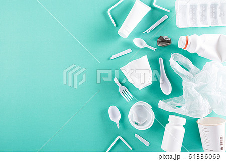 Top view of Different garbage materials on green 64336069