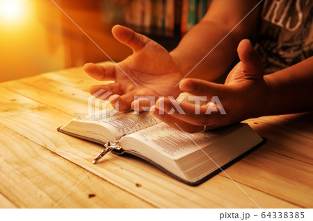 Christian hand while praying and worship for 64338385