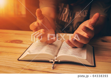 Christian hand while praying and worship for 64338393