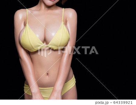Close Up Of Female Big Breasts In Yellow Bikini. Isolated On Black  Background Stock Photo, Picture and Royalty Free Image. Image 144915466.
