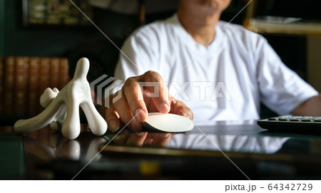 Man working from home, on his computer Man working from home, on his computer 64342729