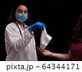 Female vet from latin america examining a cute cat 64344171