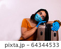 Young Latino Asian female traveler taking precautions against infectious diseases 64344533