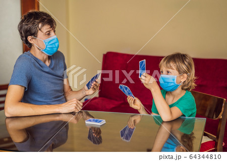 Happy Family Playing Board Game At Home. Stay at home due to quarantine. Coronovirus infection 64344810