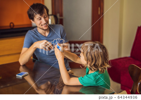 Happy Family Playing Board Game At Home 64344936