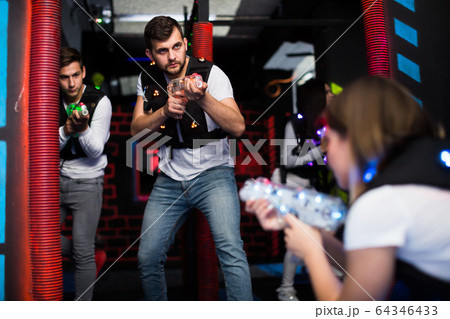 Emotional guy playing laser tag 64346433
