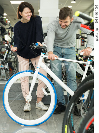 male and female choosing sport bicycle male and female choosing sport bicycle 64346454