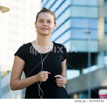 Girl jogging outdoor with music 64346592