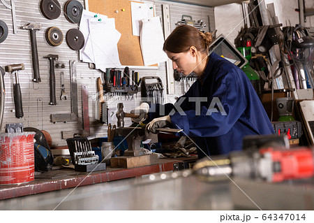Professional woman worker during work in workshop 64347014