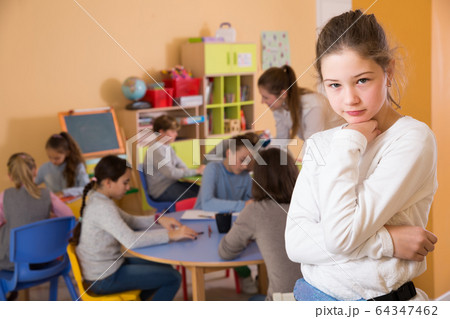 Portrait of sad brunette schoolgirl and children 64347462