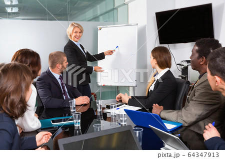 Elegant mature businesswoman discussing new project with his tea 64347913