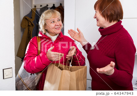 Positive woman saying goodbye to friend 64347943