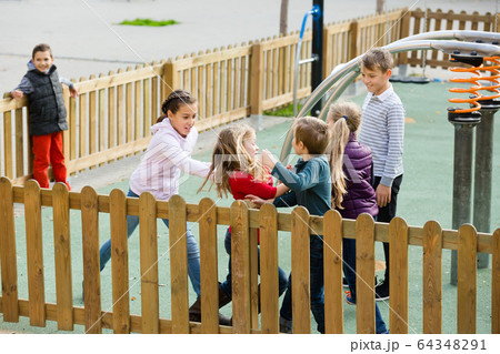 Excited kids running around while playing Excited kids running around while playing 64348291