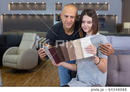 Couple holding samples of upholstery fabric Couple holding samples of upholstery fabric 64348988