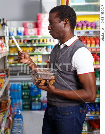 African man shopping with list 64349017