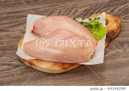 Raw chicken breast over board 64349290