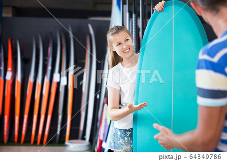 Female showing to male surfboard Female showing to male surfboard 64349786