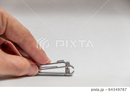 Finger touch old Nail clippers isolated on white 64349787