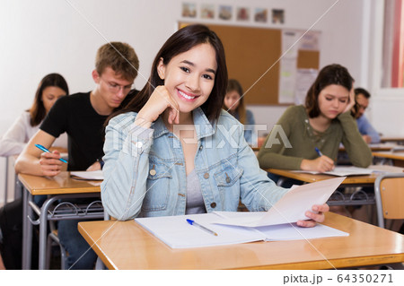 schoolgirl is sitting test and answer about task schoolgirl is sitting test and answer about task 64350271