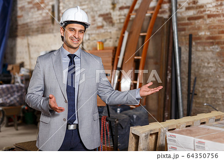 Friendly man at construction site Friendly man at construction site 64350756