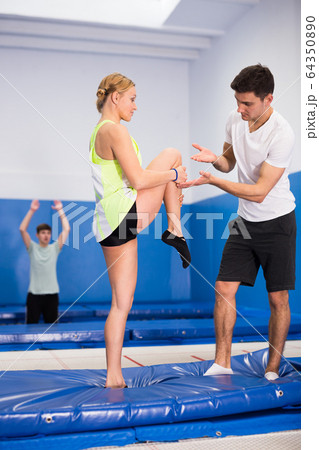 Trampoline coach training woman 64350890