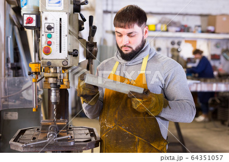 Portrait of professional man working with stainless steel Portrait of professional man working with stainless steel 64351057