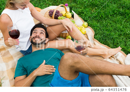 Boyfiend is relaxing on the lap of female 64351476