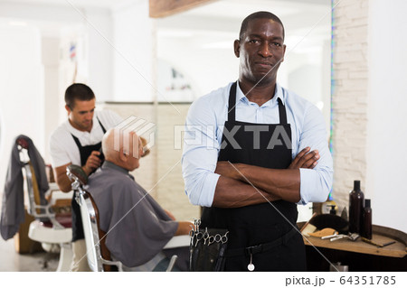 Confident African man hairdresser 64351785