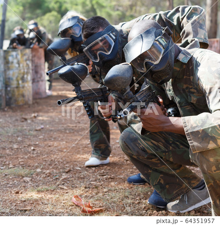 Outdoor portrait of paintball team 64351957
