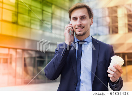 man going and talking on mobile phone man going and talking on mobile phone 64352438