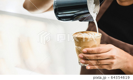 Professional barista making latte art coffee 64354619