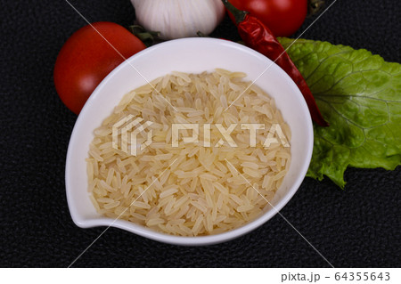 Raw uncooked rice in the bowl 64355643