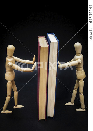 Two mannequins holding two books Two mannequins holding two books 64356544