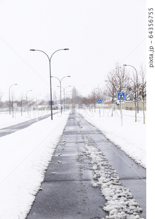 street freshly cleaned by snowplow in a city full street freshly cleaned by snowplow in a city full 64356755