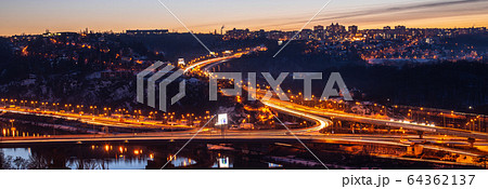 View of Barrandov Bridge over Vltava River in Branik, Prague, Czech Republic. Illuminated roads in cold winter evening View of Barrandov Bridge over Vltava River in Branik, Prague, Czech Republic. Illuminated roads in cold winter evening 64362137