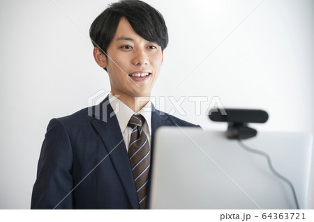 ウェブカメラを使ってオンライン面接を受ける若い男性　イメージ 64363721