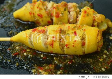 grilled squid stuffed egg dressing spicy sauce on plate 64364065