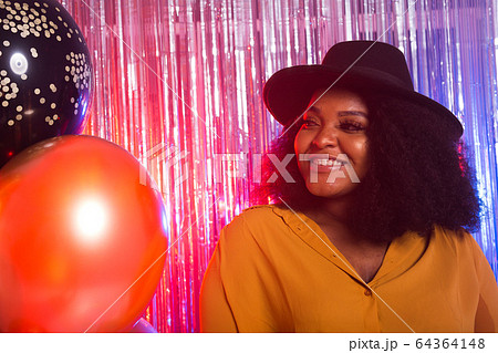 Beautiful black woman enjoying a party lifestyle. Birthday party, clubbing and holidays concept. Beautiful black woman enjoying a party lifestyle. Birthday party, clubbing and holidays concept. 64364148