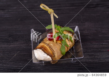 Canape of eggplant with cheese, greens and grenade bones Canape of eggplant with cheese, greens and grenade bones 64364859
