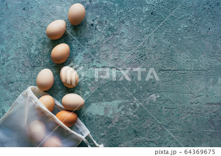 Eggs scattered from a textile shopping bag. 64369675