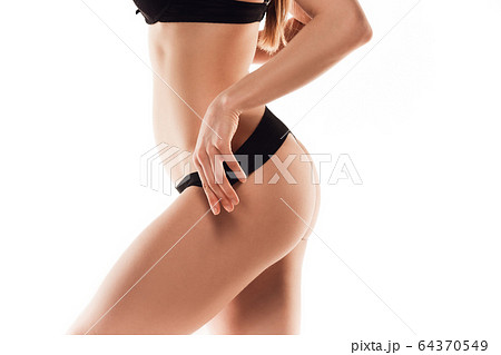 Beautiful female back and butt isolated on white background. Beauty, cosmetics, spa, depilation, treatment and fitness concept, sensual posing 64370549